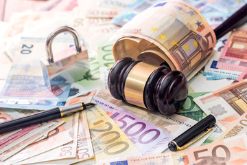 wooden gavel above wuro banknote. justice