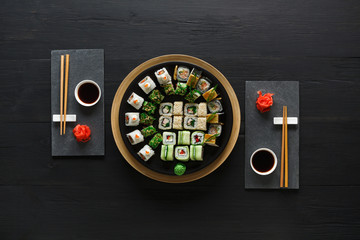 Set of sushi maki and rolls on black rustic wood, top view © Prostock-studio