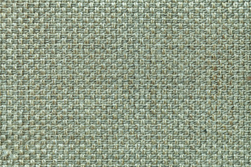 Light green textile background with checkered pattern, closeup. Structure of the fabric macro.