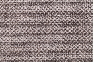 Light brown textile background with checkered pattern, closeup. Structure of the fabric macro.