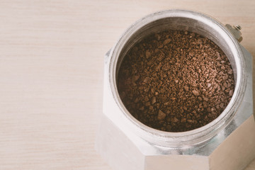 coffee powder in the italian coffee maker on wood table