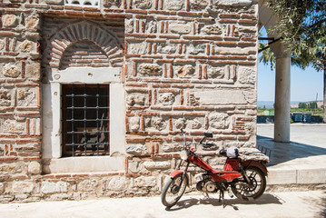 Motorcycle in front of a stone wall