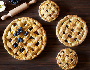 Close up. Homemade pastry apple pie pies bakery on dark wooden kitchen table with raisins,...