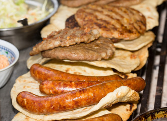 Burgers and sausages on barbecue