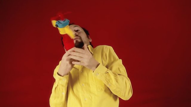 An adult man having fun playing with a plane toy. Funny cringe scene.
