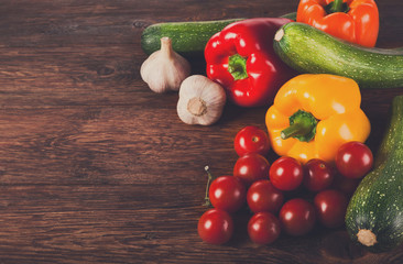 Fresh vegetables on brown wood background