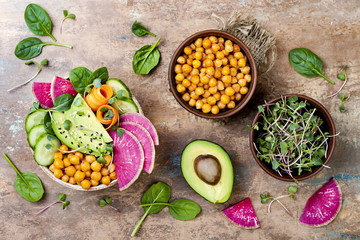 Vegan, detox Buddha bowl recipe with avocado, carrots, spinach, chickpeas and radishes. Top view,...