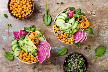 Vegan, detox Buddha bowl recipe with avocado, carrots, spinach, chickpeas and radishes. Top view,...