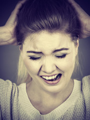 Unhappy woman screaming and yelling in pain