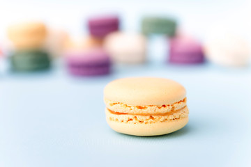 Sweet colorful macaroons on blue table background