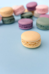 Sweet colorful macaroons on blue table background