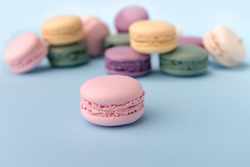 Sweet colorful macaroons on blue table background