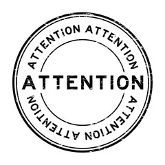 Grunge black attention round rubber seal stamp on white background