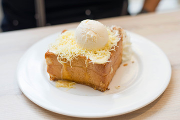 Chesse toast with ice-cream on white dish.