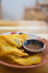 Deep fried crispy dumpling strips with spicy sauce