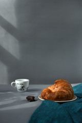 Croissant and espresso in morning sun