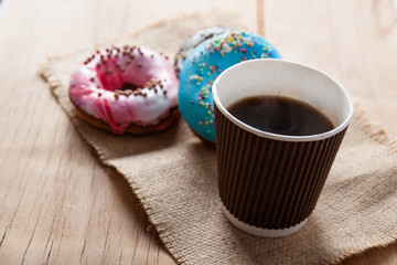 Fresh donuts close up on wood desk