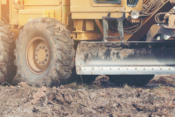 Grader leveling landfill on construction site before kick off project
