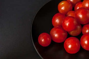 Tomatoes on black background.