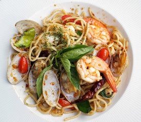 A close up dish of spaghetti with spicy prawns and clams