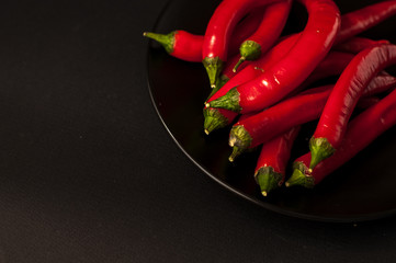 red Chili peppers on a black background