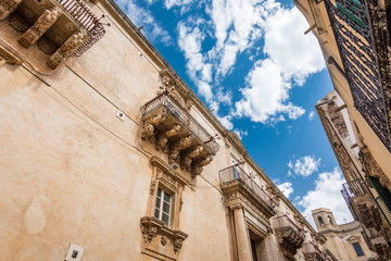 Beautiful baroque balconies of Palazzo Nicolaci Villadorata, Noto, Sicily, Italy.