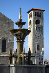 Fototapeta premium antique fountain, stone clock tower, view of city square