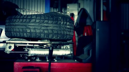 mechanic dismount tire from rim with special machine.