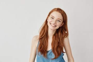 Happy cheerful ginger girl smiling looking at camera.