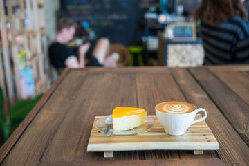 vintage style orange cake with coffee latte on wood table.