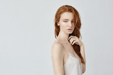 Young beautiful redhead girl posing in profile.