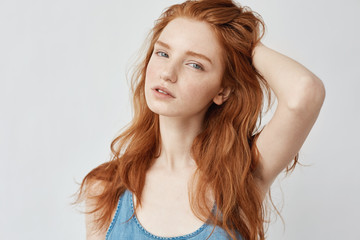 Portrait of beautiful model with foxy hair posing looking at camera.