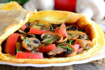 Yummy omelette with mushrooms and tomatoes. Fried omelette with mushrooms, fresh tomatoes and dill on a plate. Healthy vegetarian egg breakfast. Rustic style. Closeup