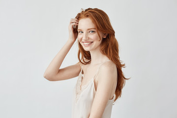 Fototapeta premium Beautiful redhead model with freckles smiling looking at camera.