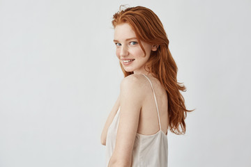 Fototapeta premium Beautiful redhead model with freckles smiling looking at camera.