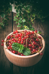 Redcurrant in wooden bowl.