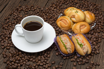 Coffee cup with bread sausage and coffee beans