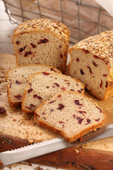 Whole grain bread with cranberry on a wooden board
