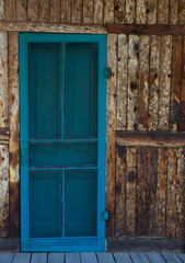 Blue Screen Door On Wooden Rustic Cabin