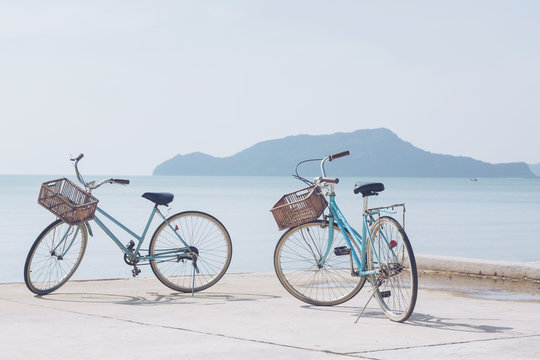 vintage bicycle on concrete road   beach over blue sea and clear blue sky background, spring or summer holiday vacation concept.soft focus