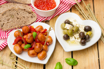 Mini Frankfurter sausage hot-dog in sour sweet sauce with bell pepper