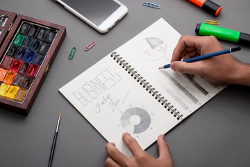 Business concept. Businessman writing idea sketch