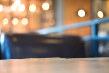 Wooden table and chair in cafe with blur bokeh abstract vintage background