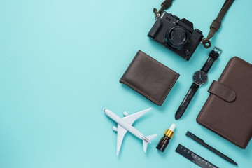 Summer traveling concept. Vacation accessories on blue background.