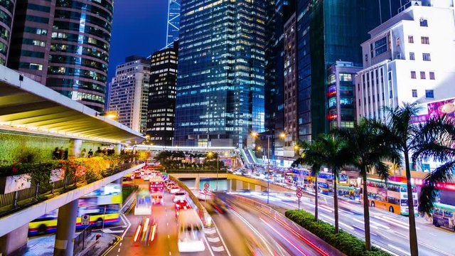 Busy City Night Timelapse. Central. Hong Kong. China. Office Buildings With Busy Traffic At Rush Hour. Many Busy People On Sidewalk And Footbridge Andine Up For The Public Transport.