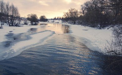 Winter landscape with flowing river