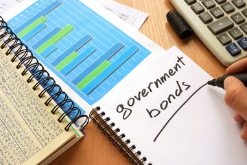 Government bonds written in a note. Trading concept.