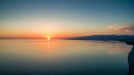 Sunset over a calm sea from the height of bird flight