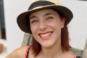 Portrait of a beautiful girl with summer hat