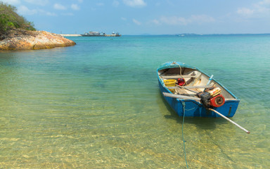 Fototapeta na wymiar Seaside beach view with fisher boat see through the water to sebase